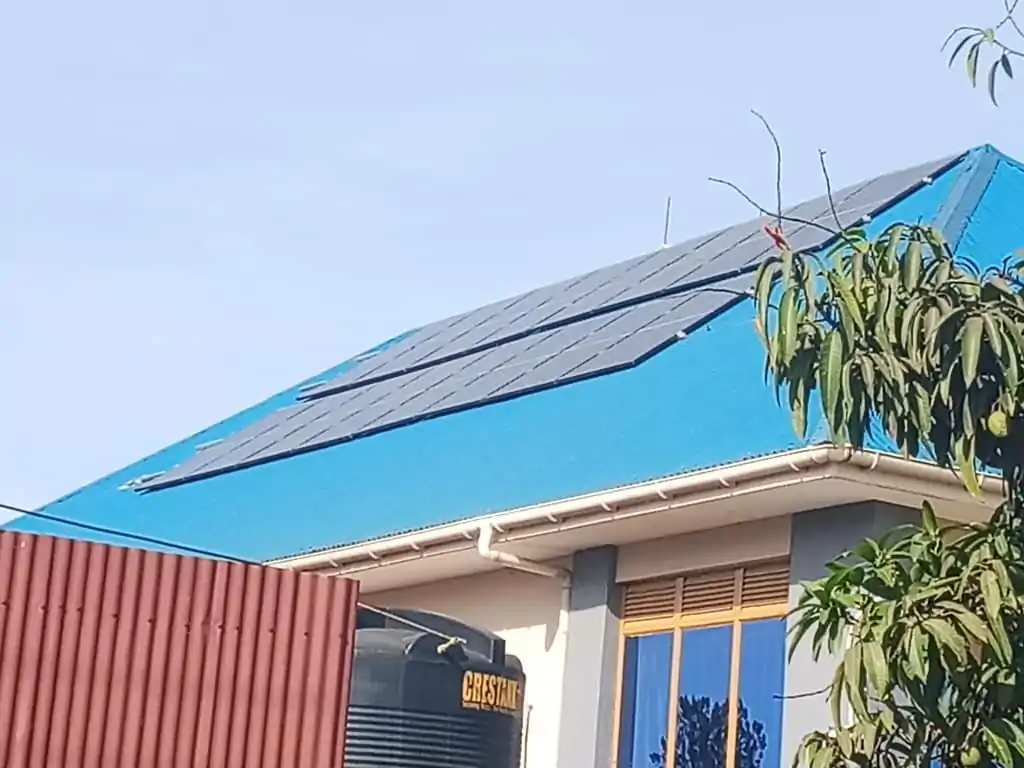 Solar panels installed on a blue rooftop